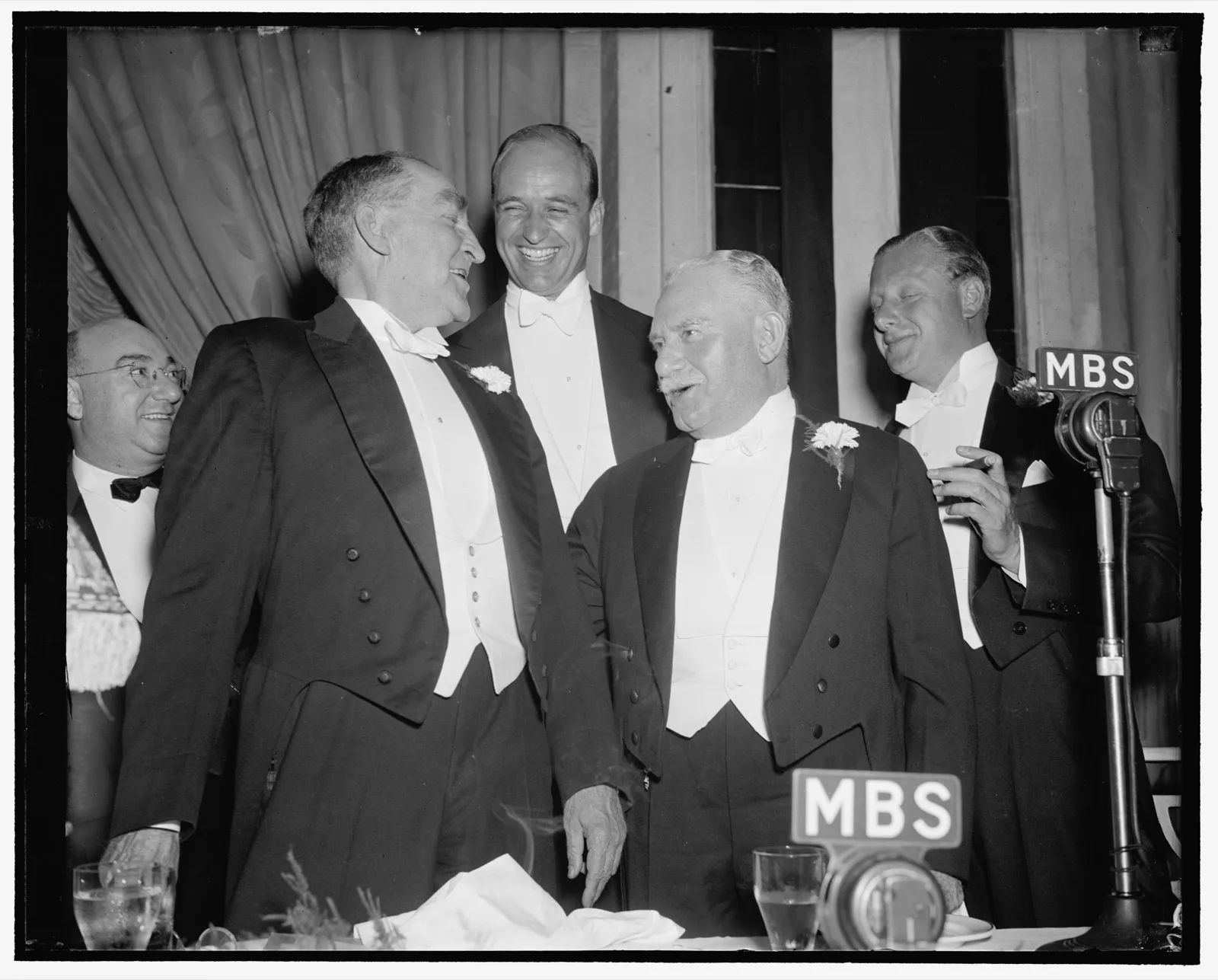 A long head table at a hotel banquet in Washington, 1938, with waiters standing behind the seated guests