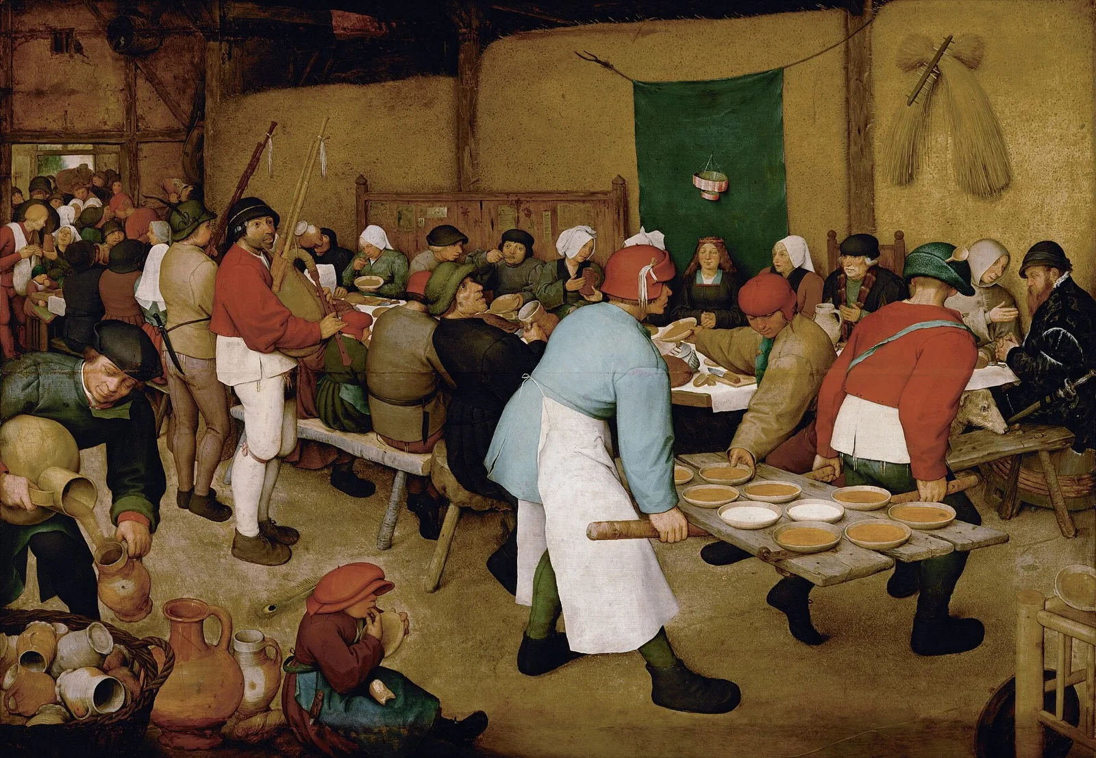 Pieter Bruegel the Elder’s Peasant Wedding, 1568: a crowded barn table, two men carrying bowls of porridge on a door taken off its hinges