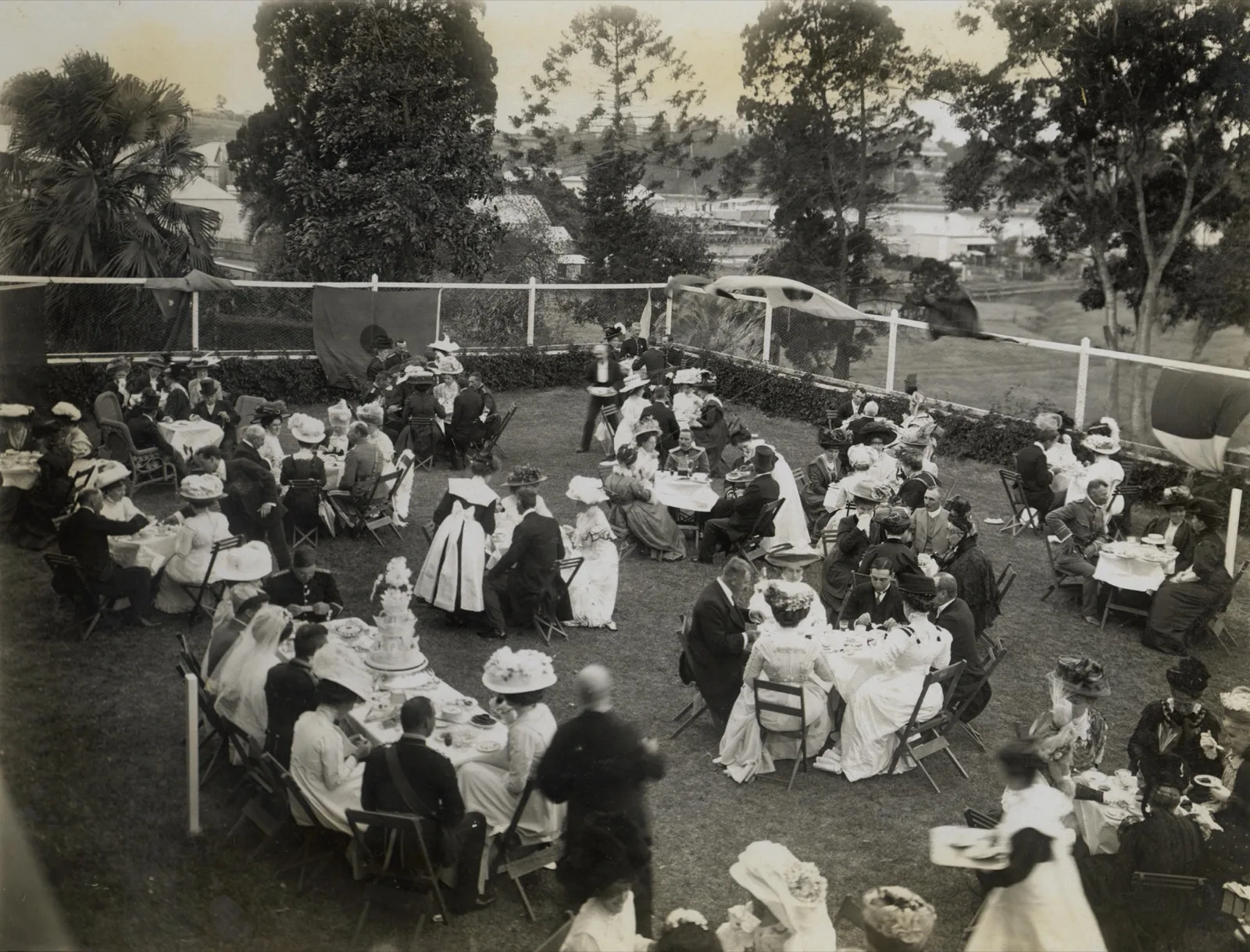 A garden wedding reception with a long bridal table, 1909