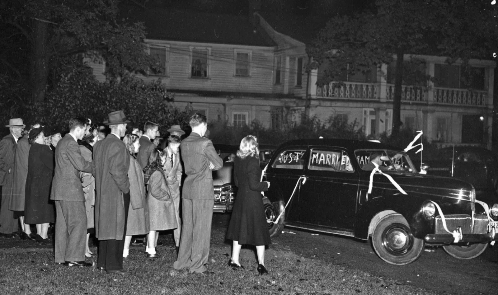 A newly married couple coming down church steps, 1948