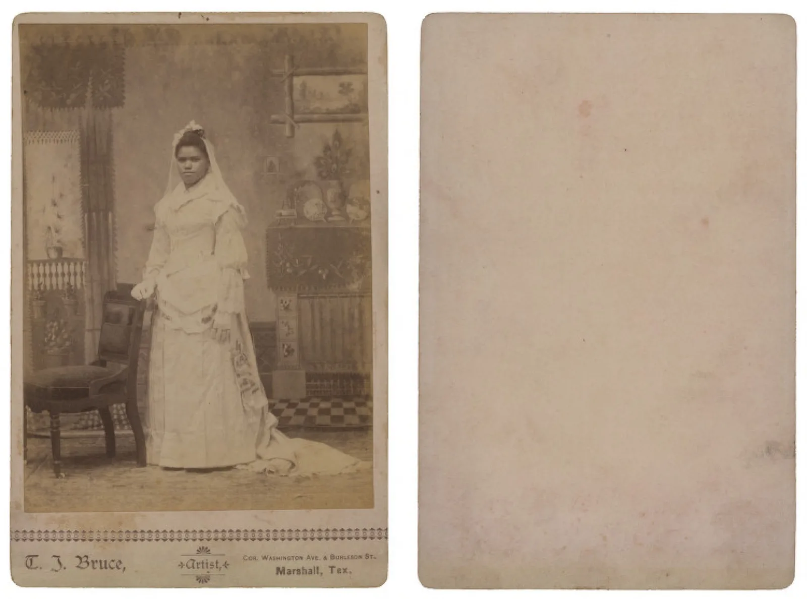 An African American bride in a white dress and veil, studio portrait, 1880s