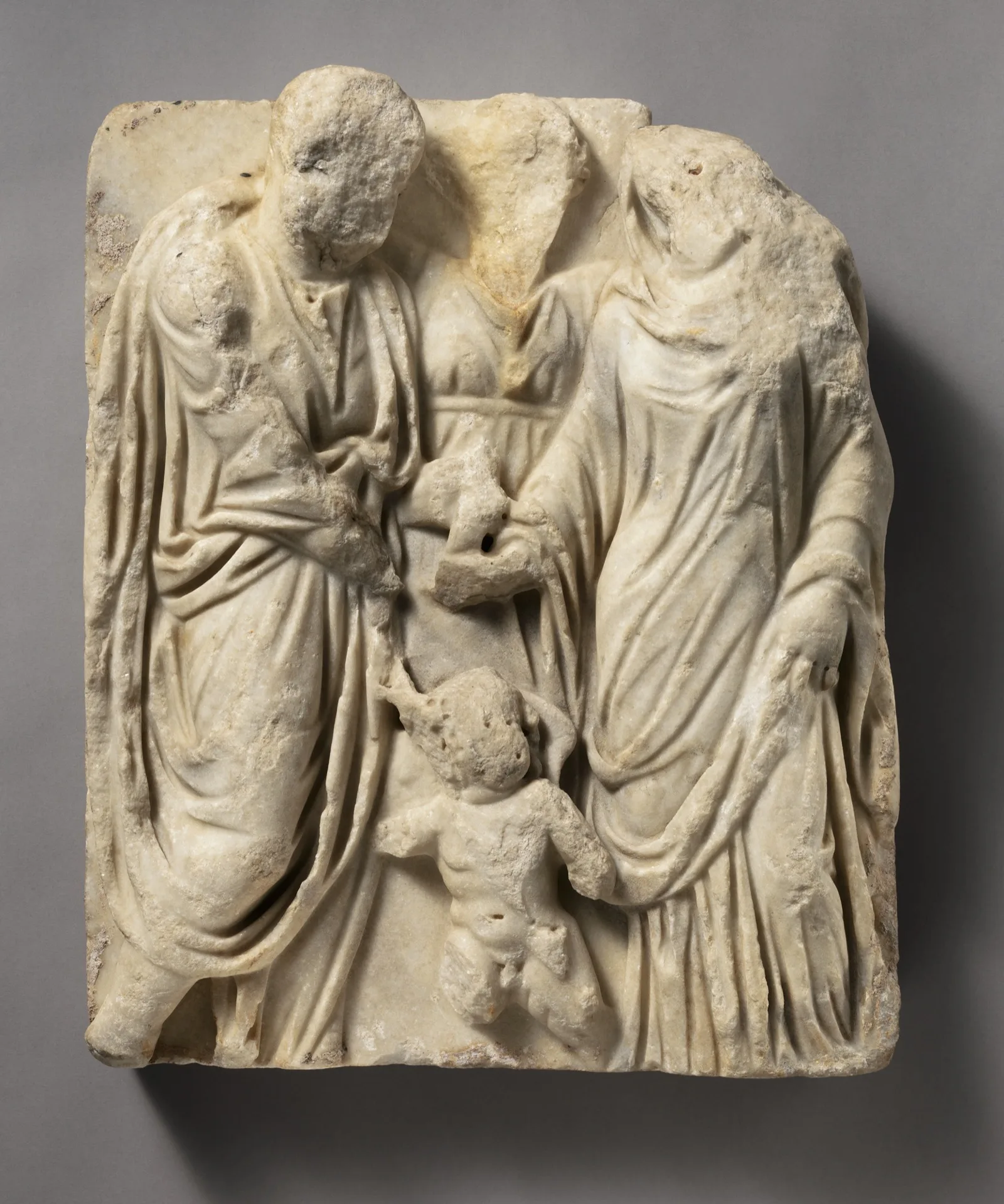 A Roman marble relief of a couple joining right hands