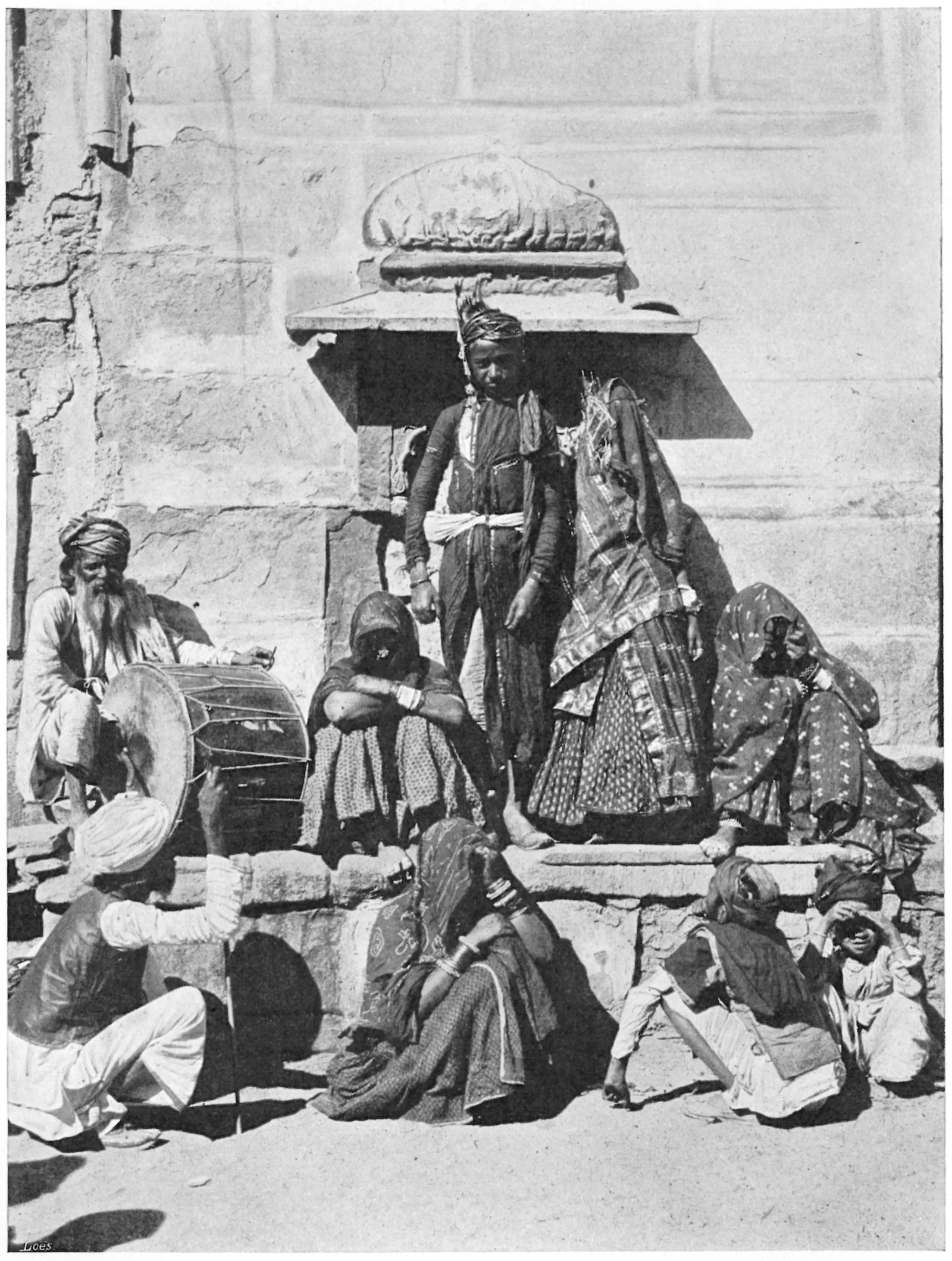 A young Rajput couple in wedding dress surrounded by relatives, 1903