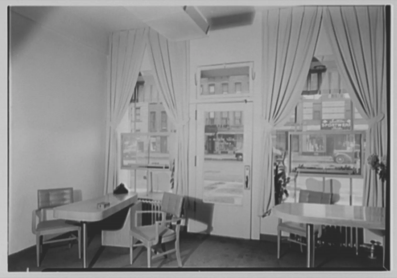 The interior of a New York caterer’s showroom in 1944: draped tables, chairs and a display of settings