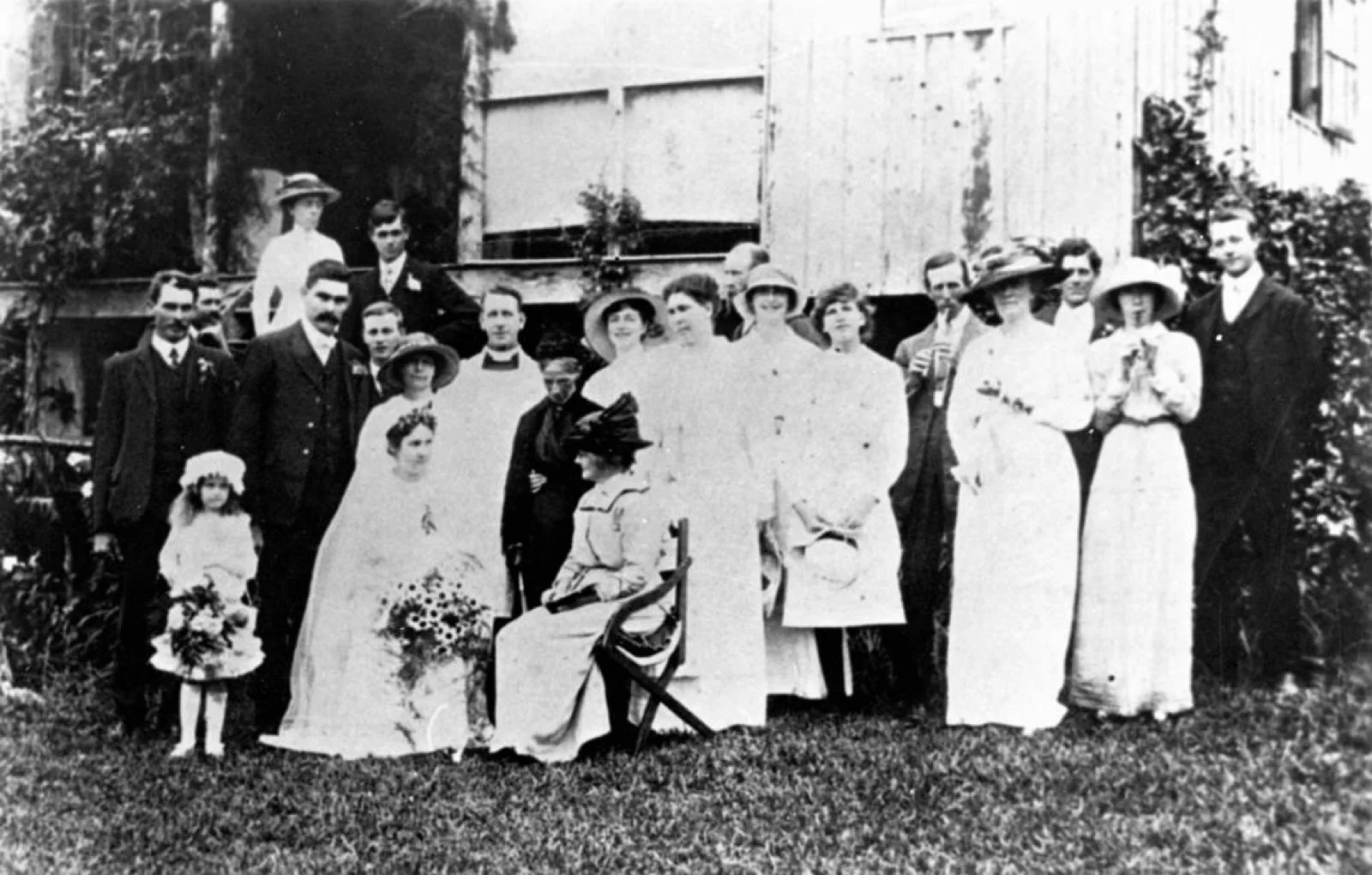A wedding party posed in a garden, 1914