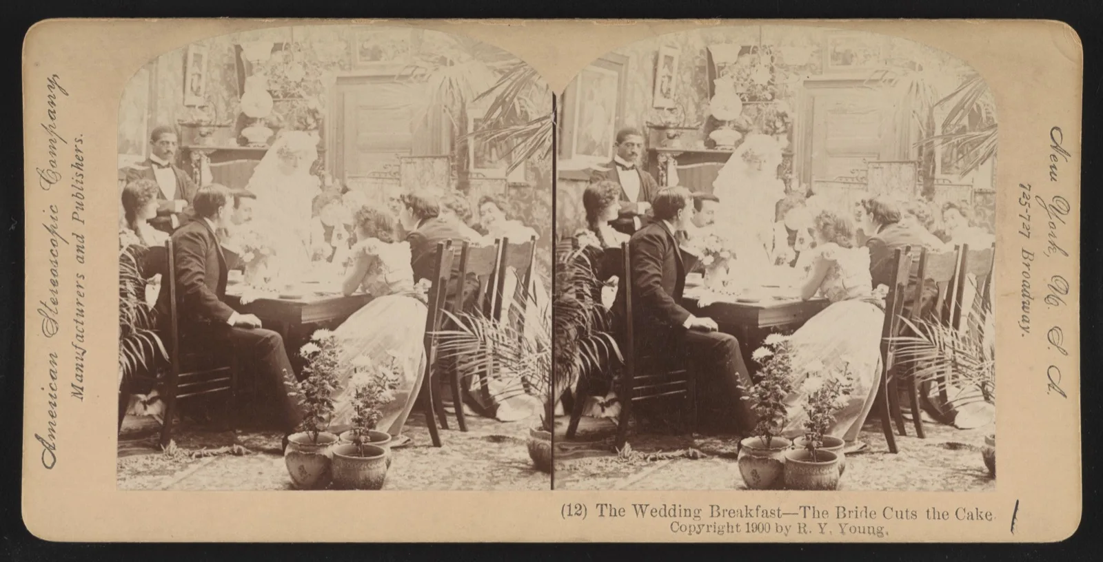 A staged 1900 stereograph of a wedding breakfast: the bride, standing, cuts a tall white cake while guests watch