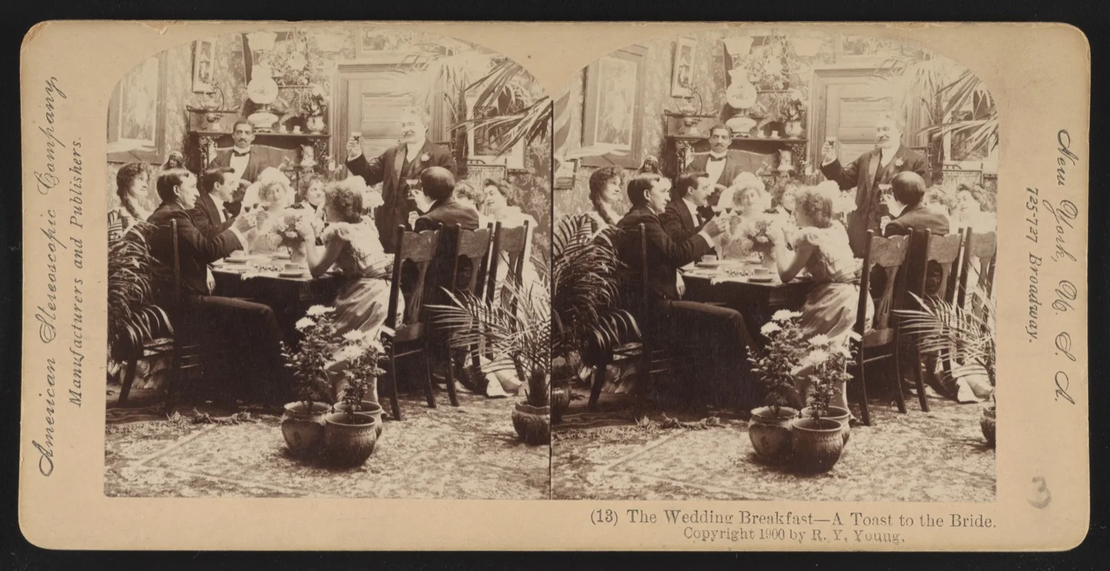 A staged 1900 stereograph of a wedding breakfast: guests around a table raise glasses to the seated bride